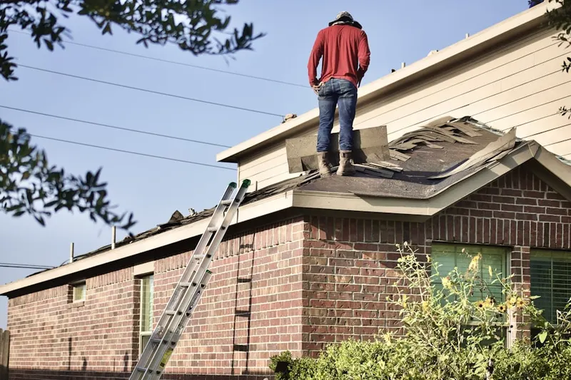 Professional roofer working on a residential roof in Saratoga Springs